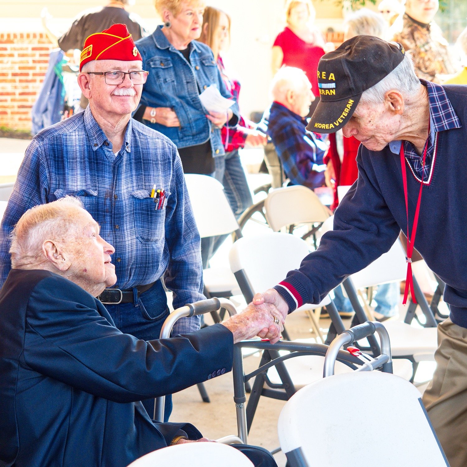 Jim "Coach" Armstrong (right) shakes the hand of James Krodel, who fought at Iwo Jima 77 years prior.